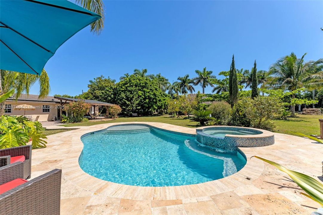 La Chakana ~ pool / spa with travertine pavers adjacent to the entertainers tiki hut WITH rear view of home