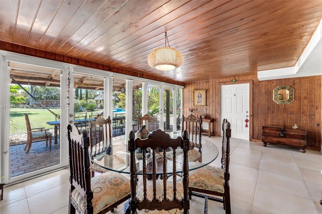 the Florida room overlooks the amazing property. the cabana suite door seen in photo has additional access from an exterior private entrance. ideal for overnight guests. current use is dining room.