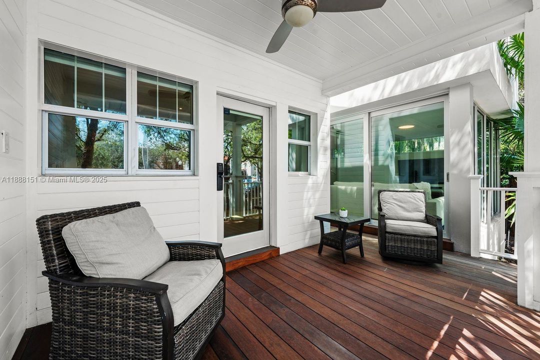 Bright sunroom with wraparound windows and tropical views — ideal for reading nook, yoga, or home office.