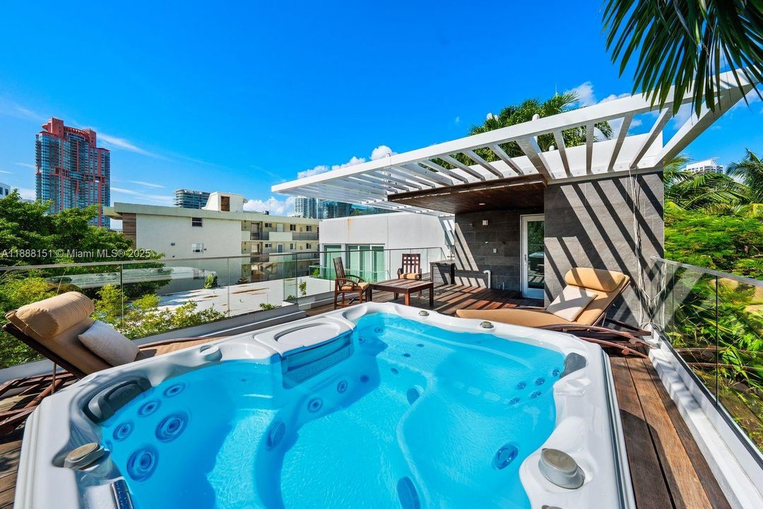 Resort-style swimming pool surrounded by palm trees — enjoy Miami Beach luxury living just steps from the ocean.