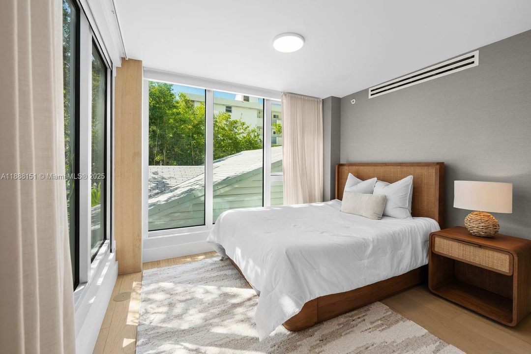 Guest bedroom with abundant natural light and clean aesthetic — perfect Miami Beach getaway space.