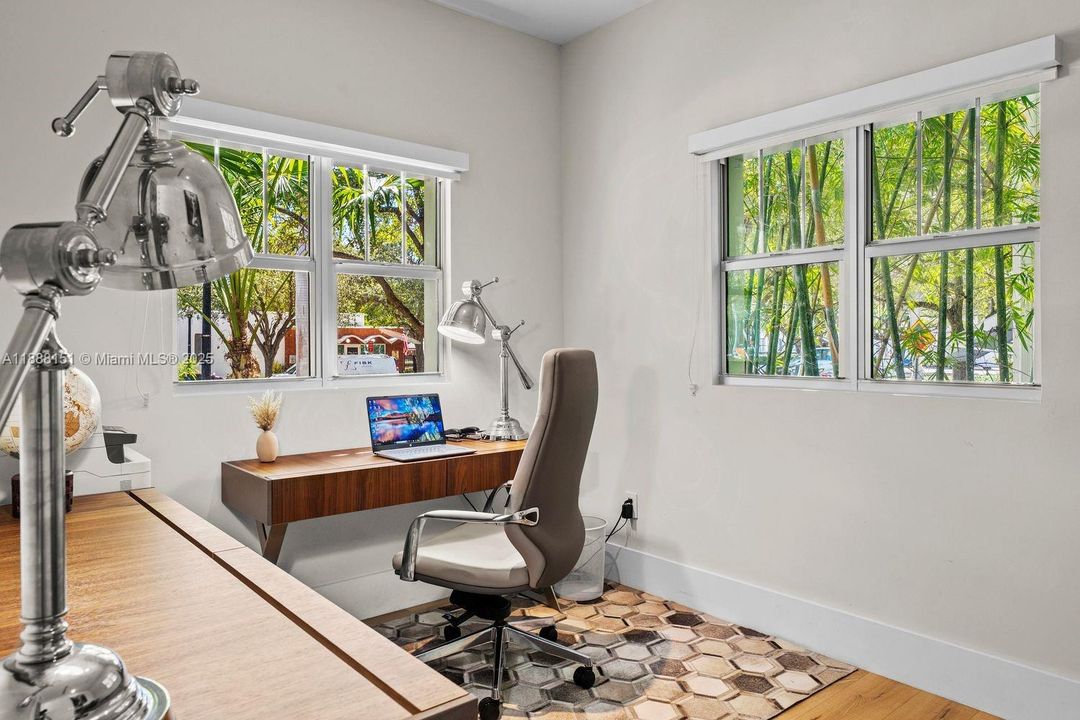 Bright home office with large windows and greenery views — ideal remote-work setup in Miami Beach.