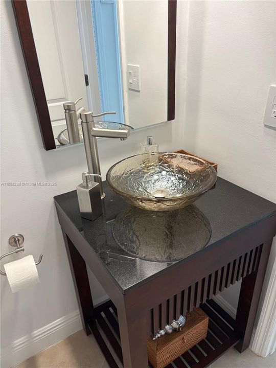 The vanity of the half bath room.