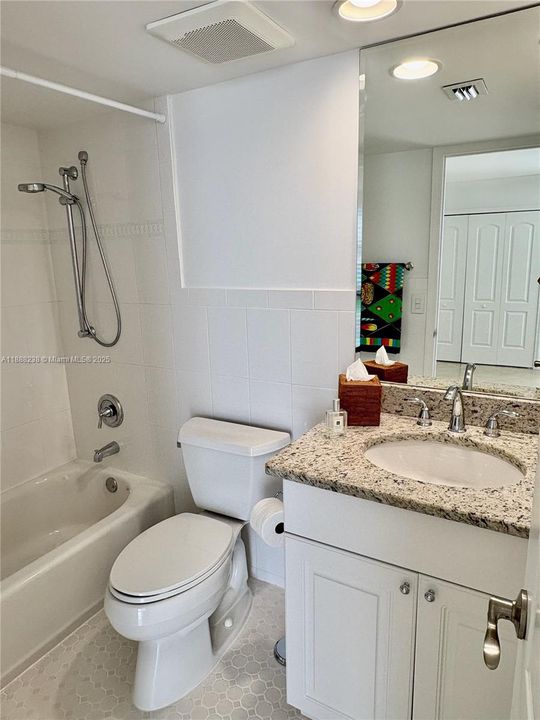 The ensuite bathroom features a vanity with one sink and a tub with a shower!