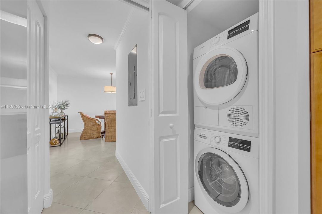 The open laundry closet with a Bosch washing machine and a Bosch dryer. The dryer was replaced in 2025!