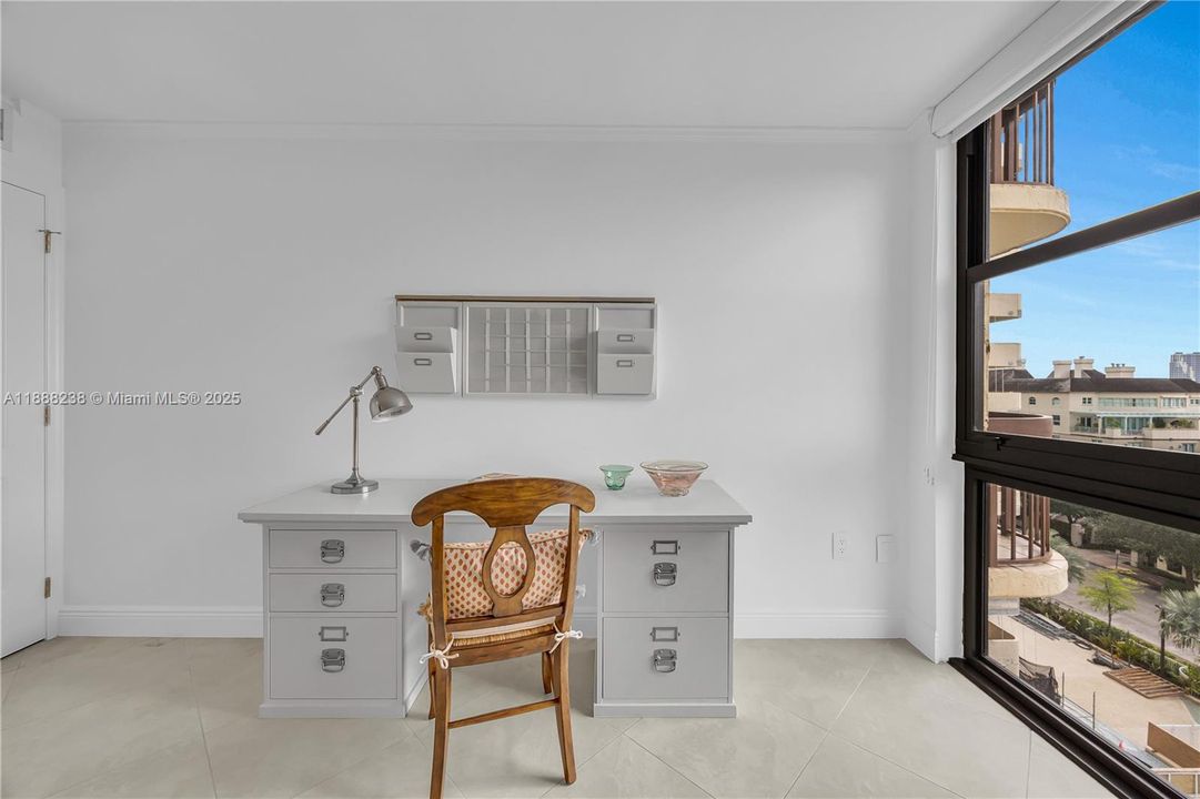 A view towards the office desk and the view towards the window.