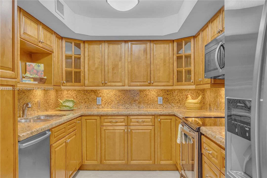 The kitchen with its granite countertop, Bosch dishwasher, LG microwave, Kenmore Elite free-standing electric range and a Kenmore Elite side-by-side refrigerator