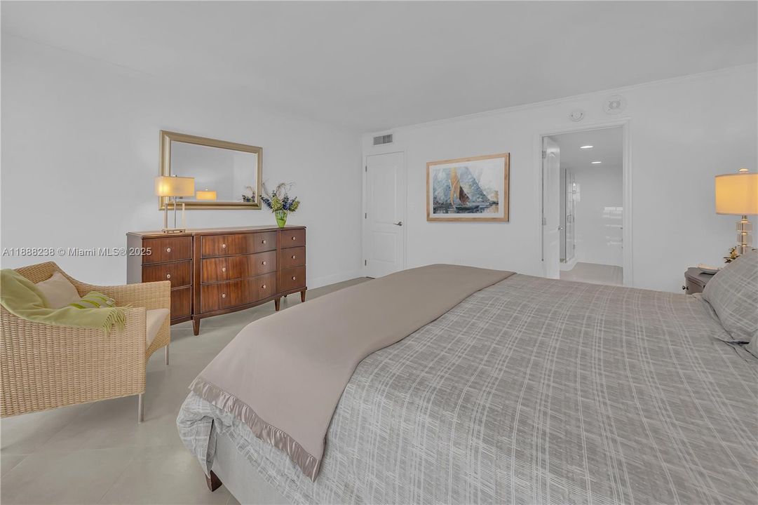 This view shows the door leading to the living area and provides a view into the master Bath room. Note: The picture shown on the wall has been virtually added.