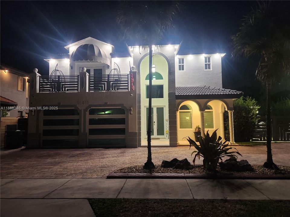 Stunning nighttime view with beautiful lighting that highlights the charm of the home.