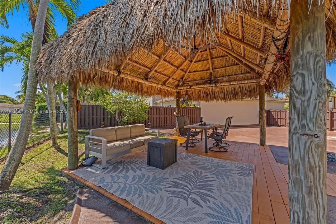 Beautiful tiki-style deck and outdoor entertainment area perfect for relaxing and hosting gatherings in South Florida’s warm climate.