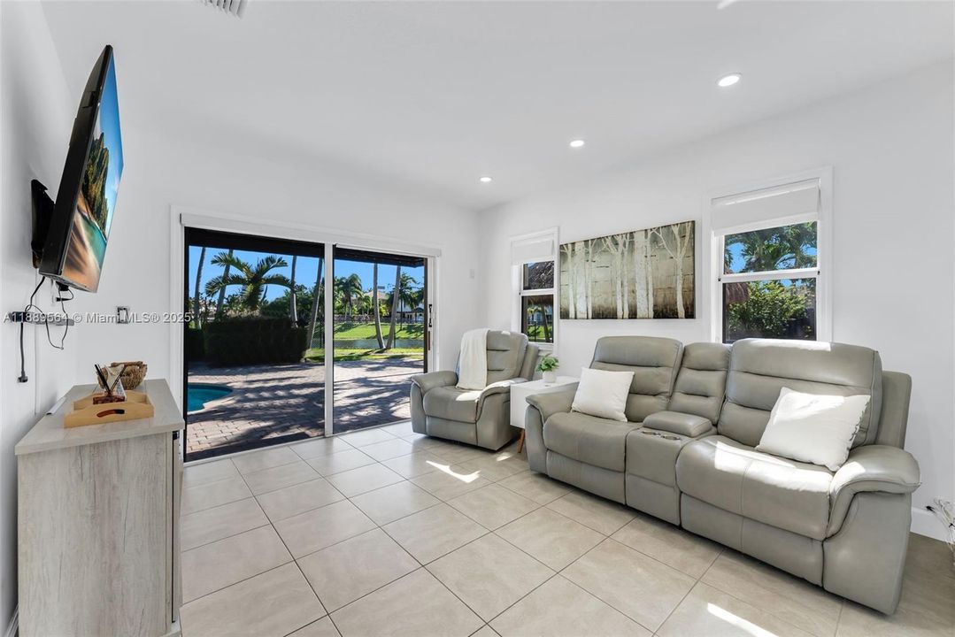 Spacious family area with sleek flooring, neutral tones, and a seamless connection to the dining and kitchen areas.