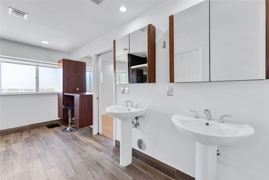Bright full bathroom with modern finishes and ample vanity space.