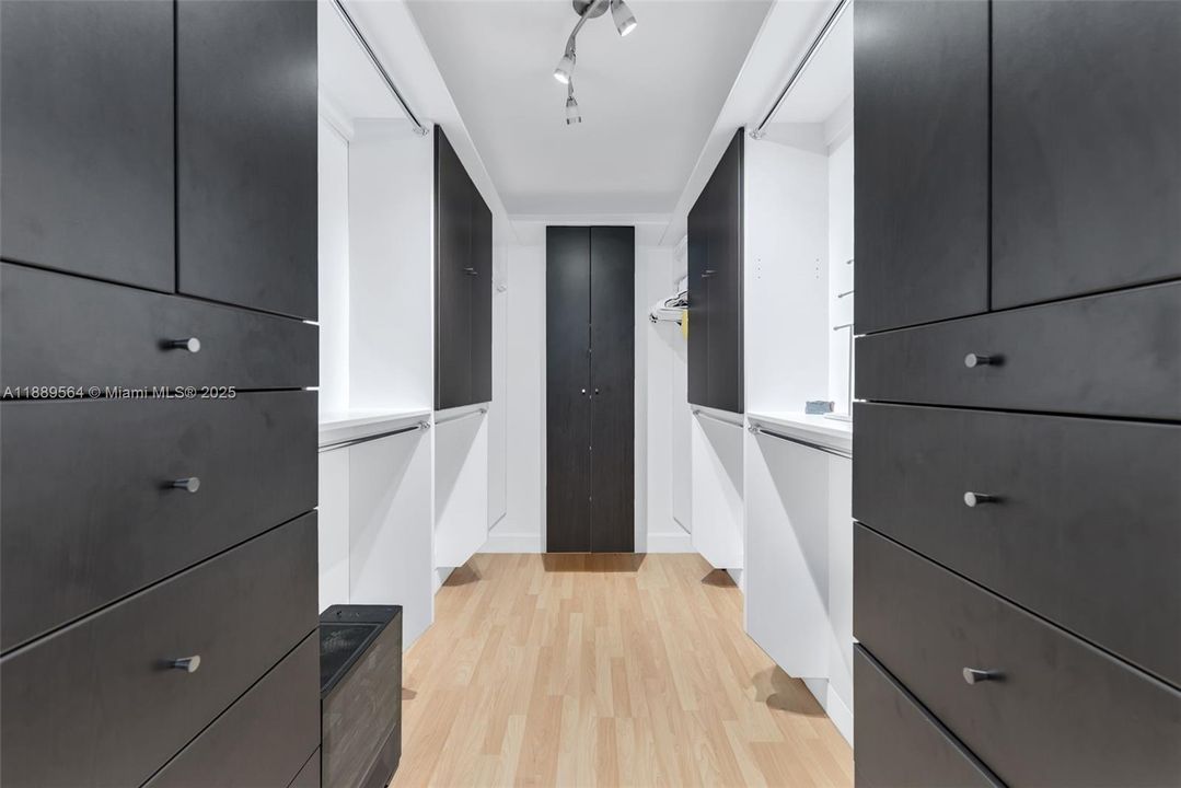 Expansive walk-in closet with custom built-ins for organized storage and style.