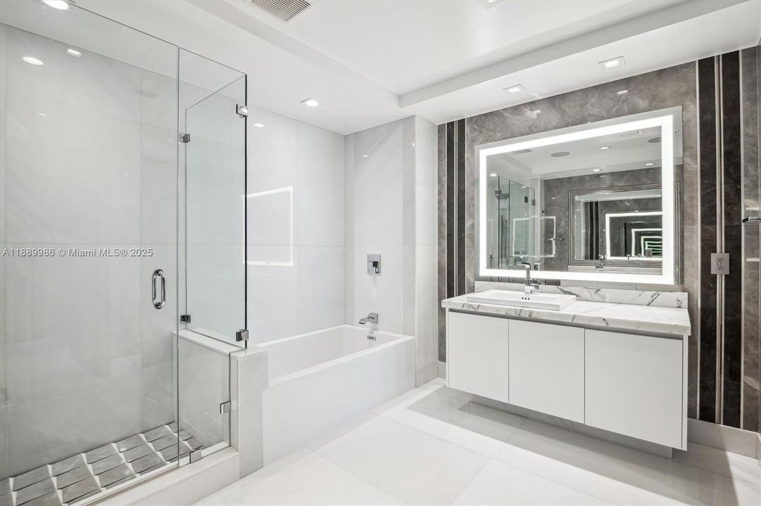 - Junior Suite Bathroom - Dual Sinks, Marble Counters, Tub & Standup Shower. Bathroom Fixtures are by Grohe & Marble Flooring Throughout & Porcelain Wall Design by Intero Futuro.