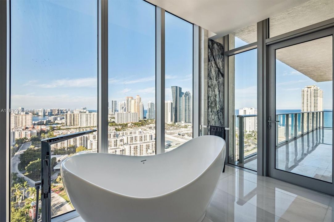 - Freestanding Soaker Bathtub w/ Ocean & City Skyline Views. Privacy shades installed. Access to Balcony.