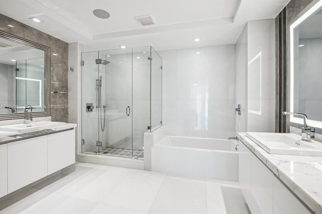 Junior Suite Bathroom - Dual Sinks, Tub & Standup Shower. Bathroom Fixtures are by Grohe & Marble Flooring Throughout.