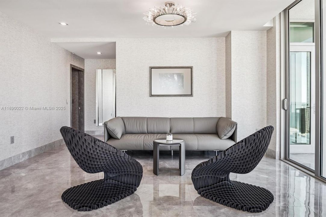 Primary Bedroom Sitting Area. Artefacto Sculptural Chairs, Modloft Leather Couch & Glass/Metallic Chandelier.
