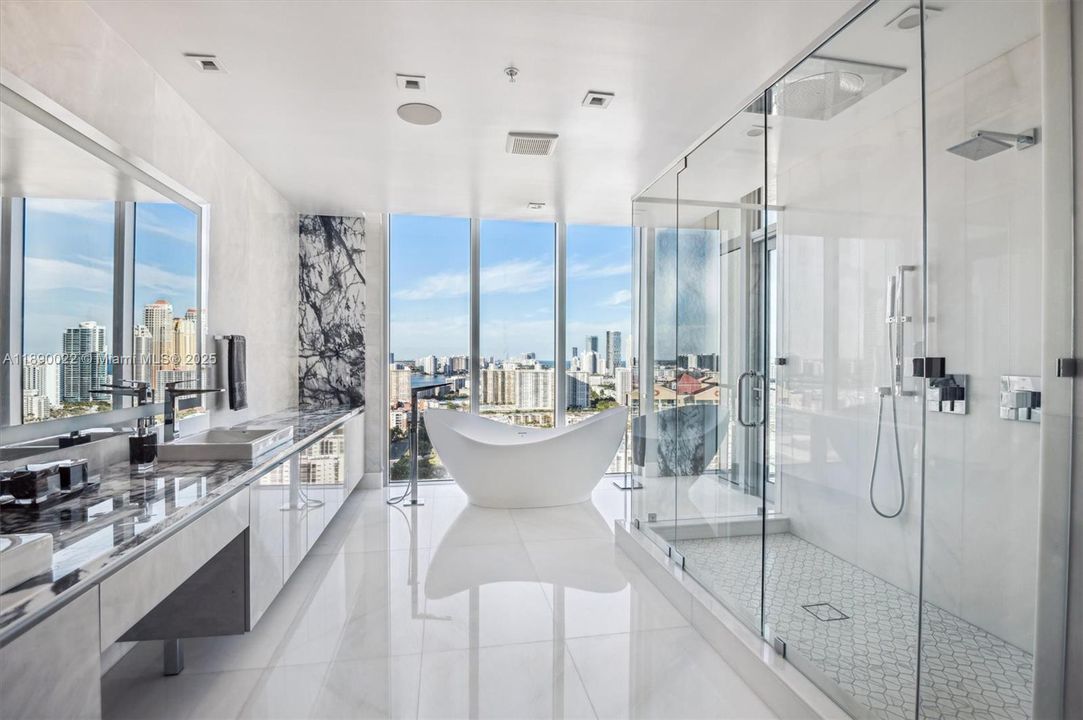 Marble Countertops, Custom Built Out Cabinetry & Linen Closet, Grohe Fixtures - Faucets, Tub Filler, Standup Shower w/ Rain Showerhead; MTI Soaker Bathtub, Seura Vanishing TV Mirror.