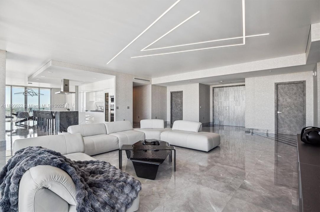 Open Layout Living / Kitchen / Dining Areas. Detailed Stretch Ceiling w/ Custom Linear LED Lighting.