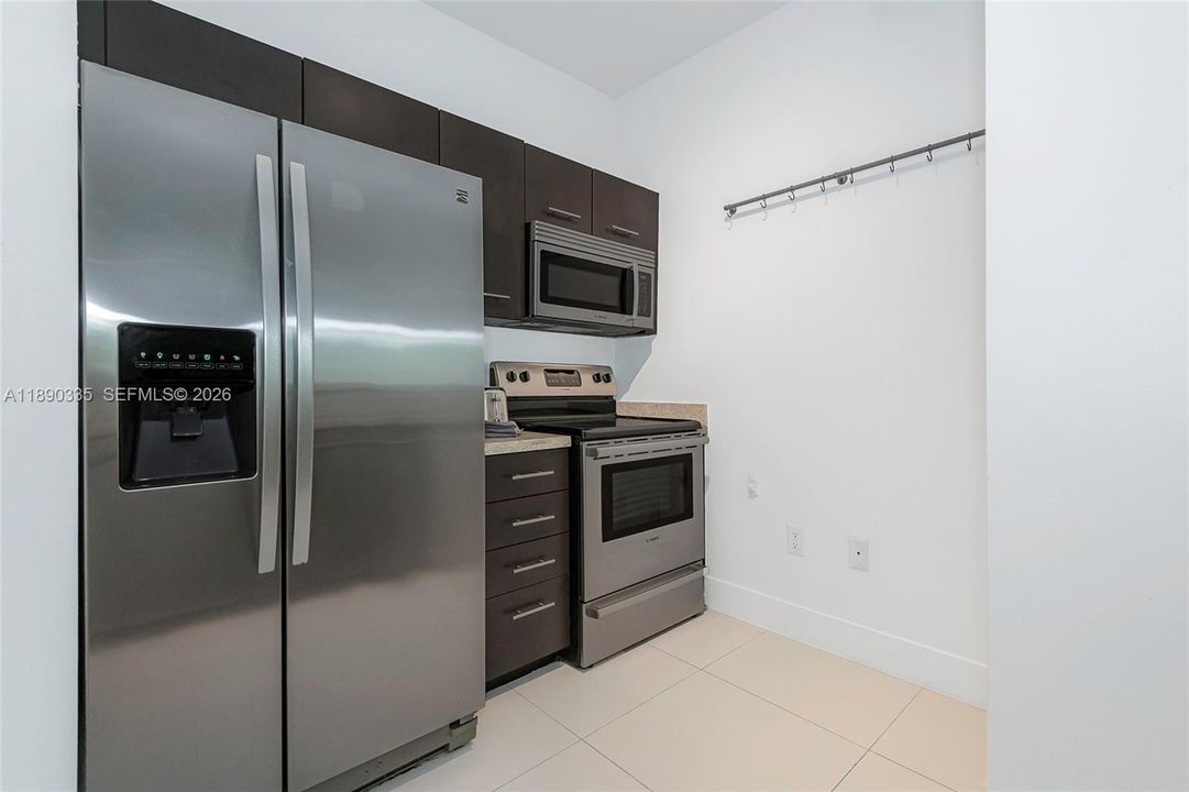Modern open kitchen w/SS appliances