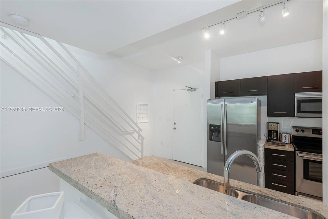 view to entrance door and stairwell to 2nd floor