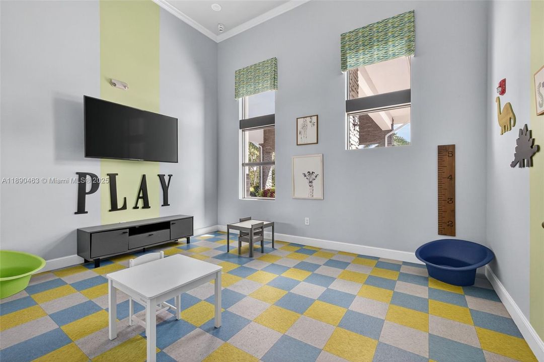 Colorful kids’ play room right by the community gym — little ones can stay busy and safe while you work out.
