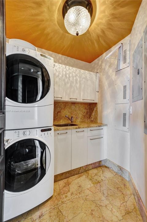Huge washer/dryer with lots of cabinetry