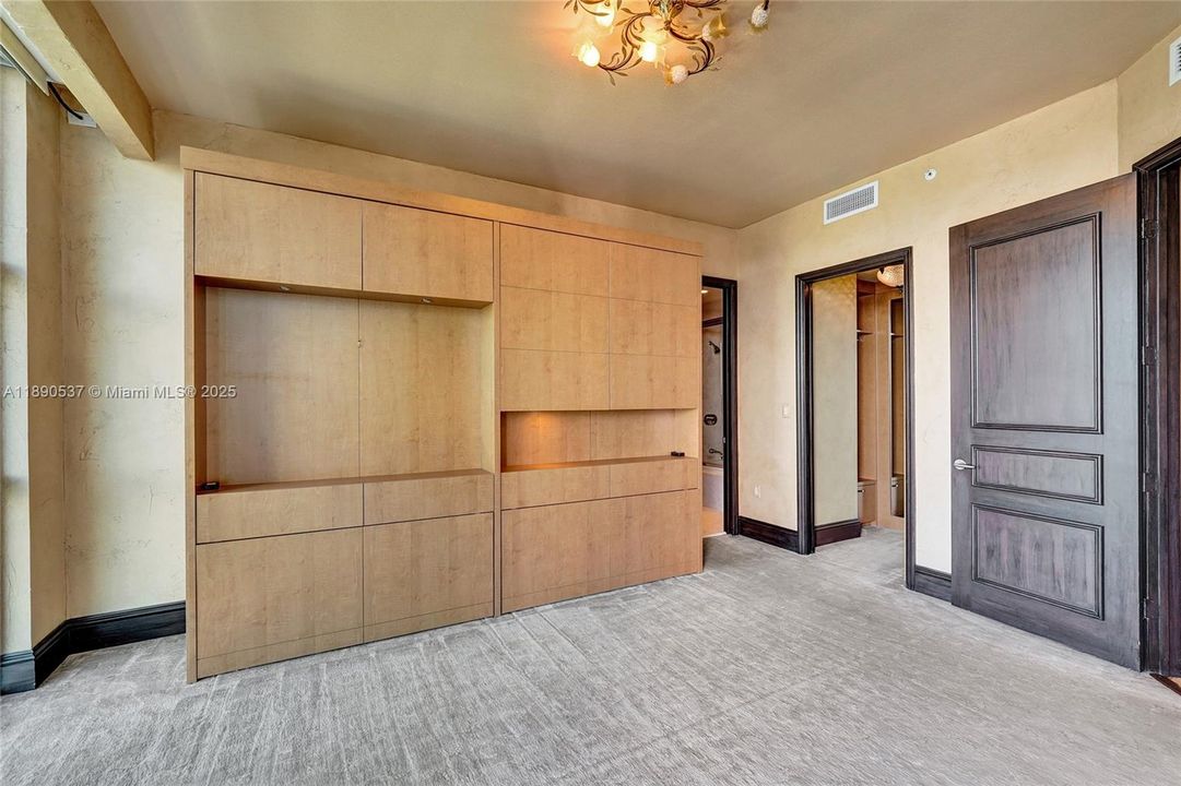 Another bedroom with built -ins and Murphy bed