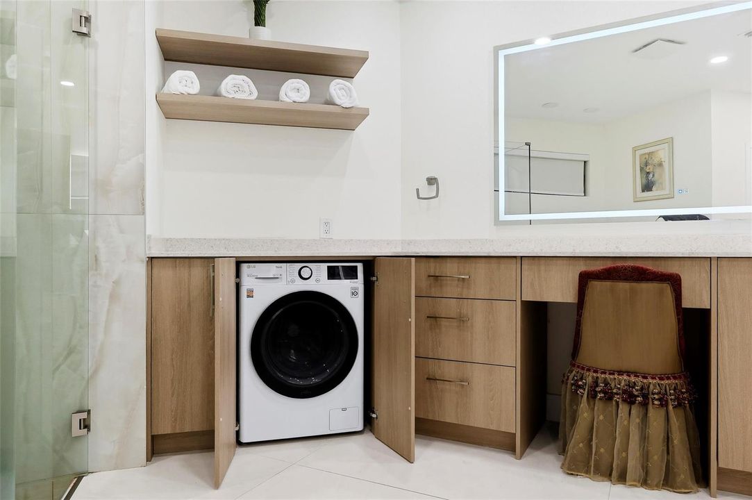 Dual washer and dryer in bathroom.