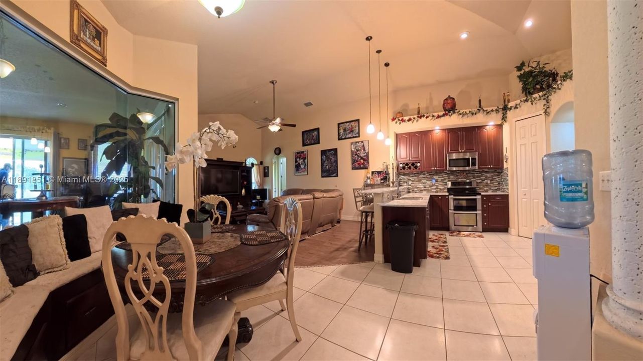 Breakfast area featuring tiled floors & bench seating, off bonus room, kitchen and family room.