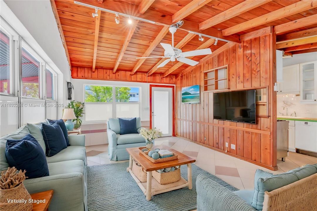Living room to back door virtually staged.
