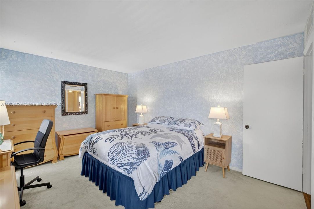 Guest Bedroom with plenty of space and tons of storage w/ wall to wall closet. Overlooks side of building