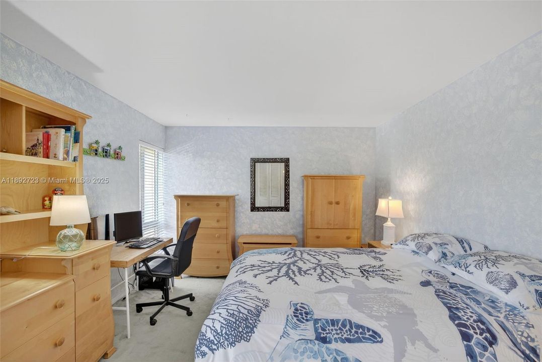 Guest Bedroom with plenty of space and tons of storage w/ wall to wall closet. Overlooks side of building