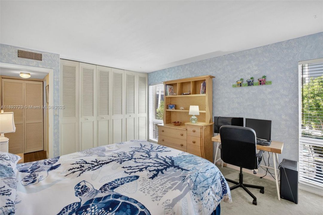 Guest Bedroom with plenty of space and tons of storage w/ wall to wall closet. Overlooks side of building