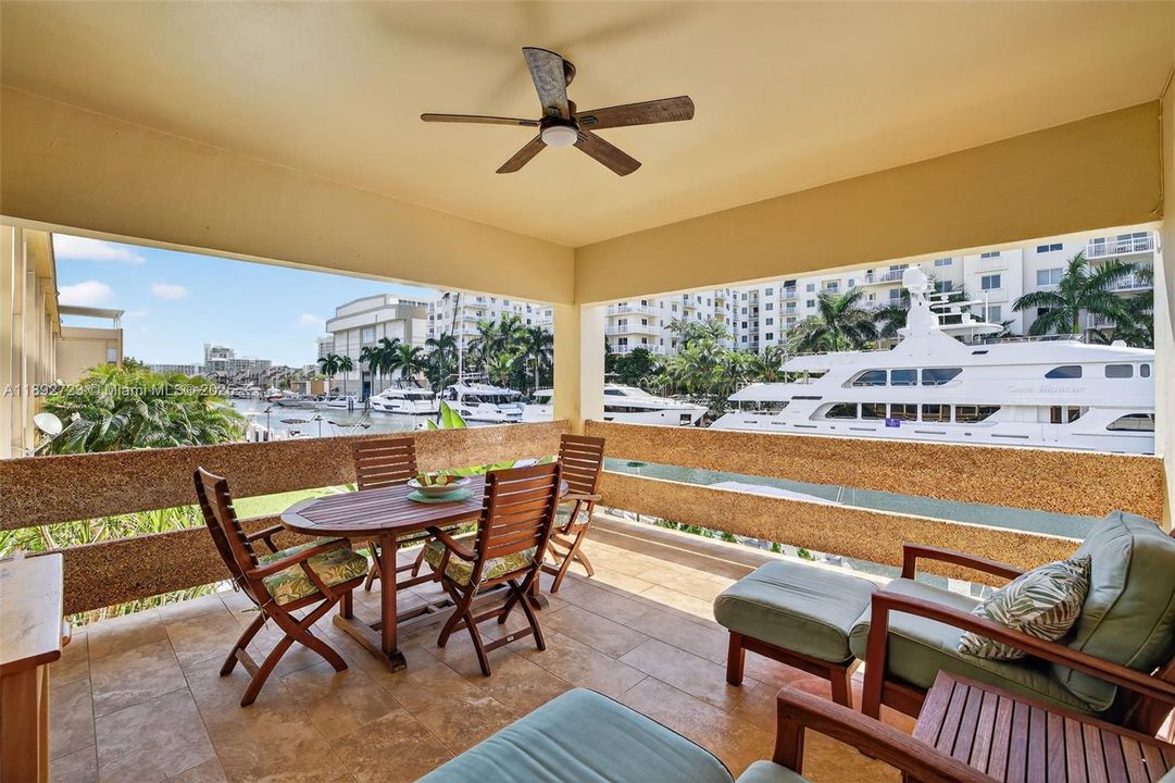 Large newly tiled covered terrace with room for a dining table and several chairs / lounges overlooking the water to the southeast, look out and see mega yachts