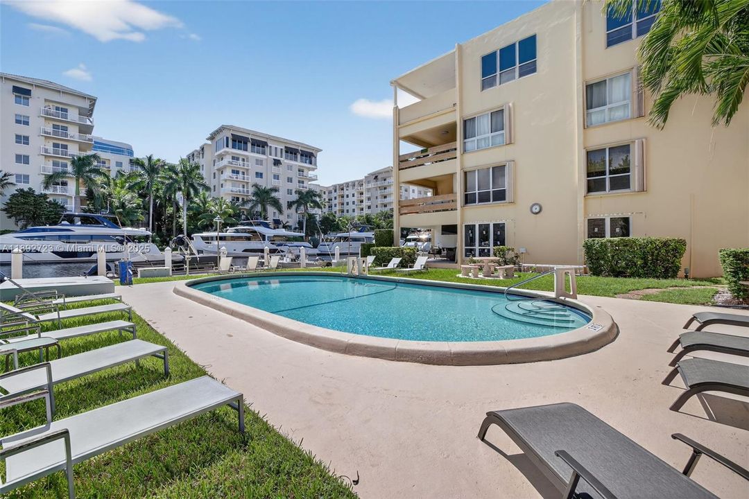 Pool directly overlooks the mega yachts across the canal. Nice patio furniture surrounds the pool