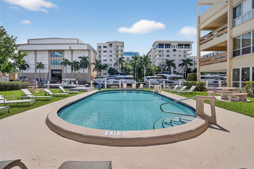 Pool directly overlooks the mega yachts across the canal