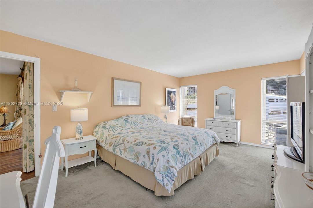 Oversized primary bedroom w/ room for all your furniture and windows on both sides - great natural light and space w/ a walk in closet and en suite bathroom