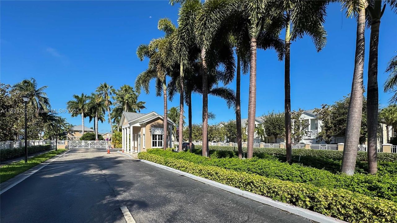Gate Entrance for residents and visitors surrounded by beautiful palm trees