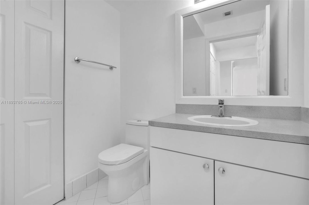 Half bathroom with storage closet.