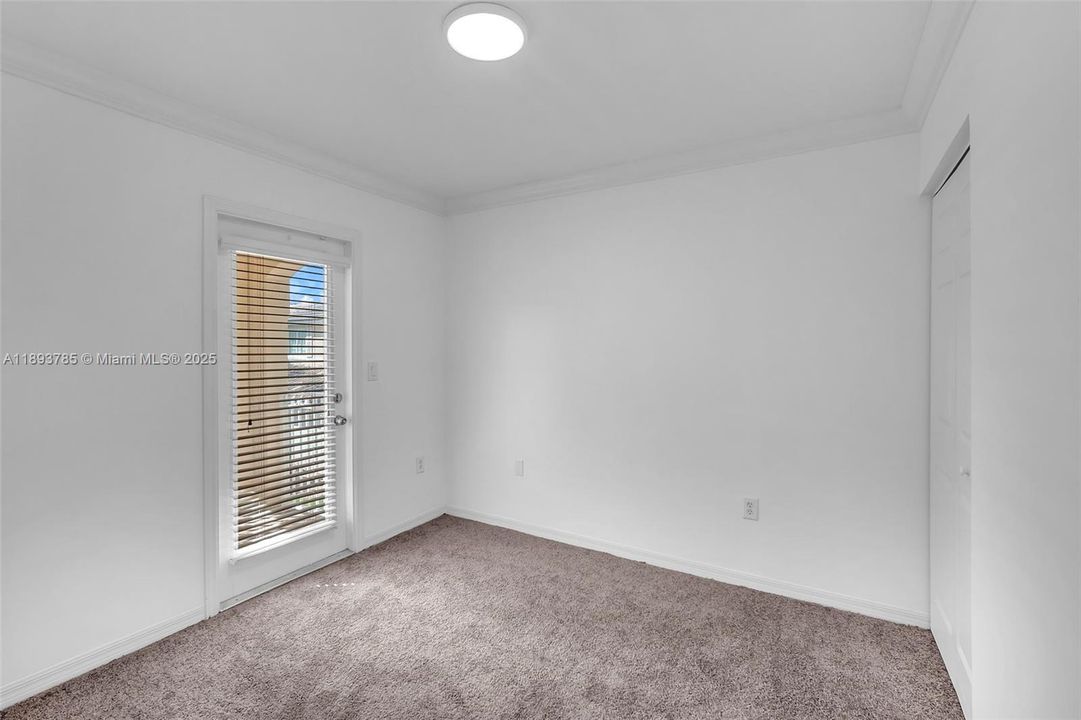 Bedroom upstairs with balcony.