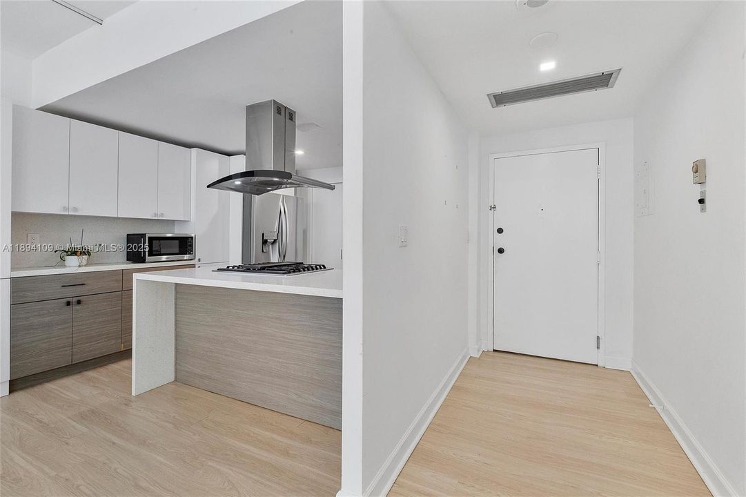 This photo shows the foyer entry in relation to the kitchen area.