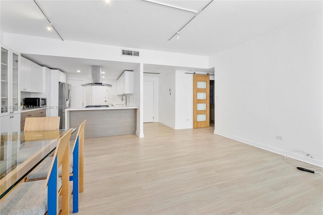 Open concept view of living room with entry to bathroom and bedroom.