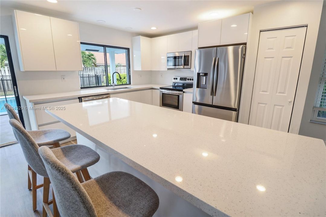 Stainless steel appliances are seamlessly integrated for a clean, contemporary look.