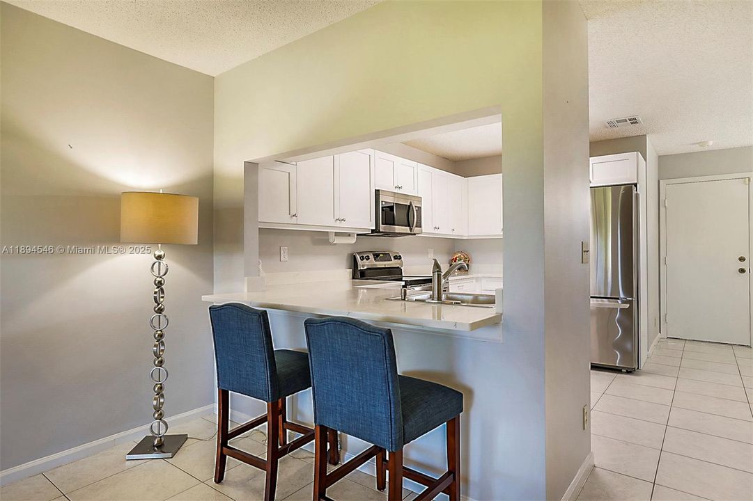 Redone Kitchen SS appliances, Quartz countertops and new cabinets built in throughout the kitchen