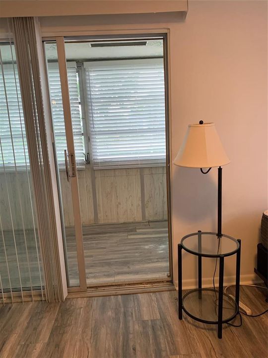 Sliding doors into sunroom from Bedroom.