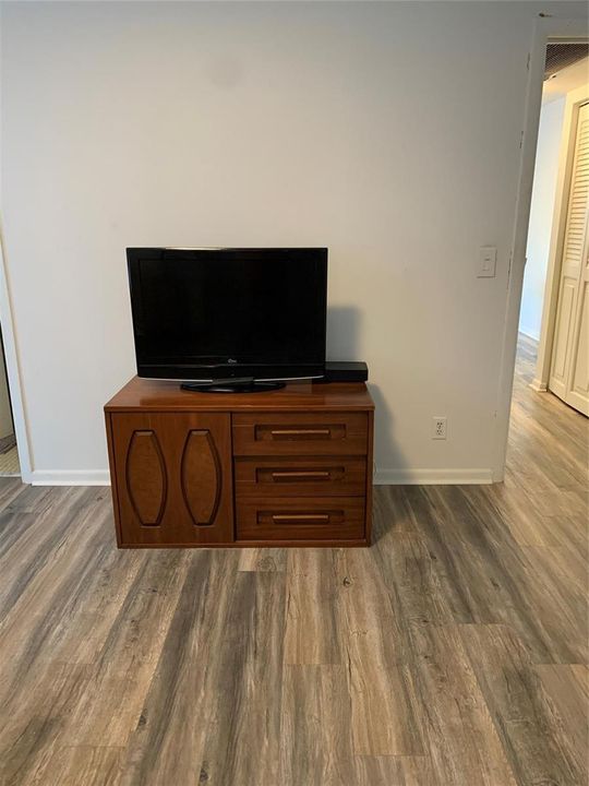 Television and Cabinetry in Bedroom.