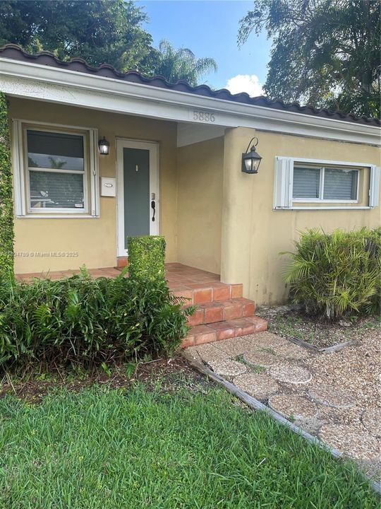 Driveway leading to front entrance with impact door.