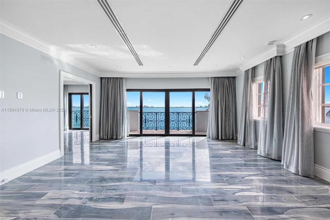 Second primary suite (corner): dual rooms, bay-view terrace, en-suite bath & closet