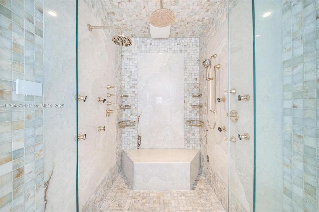 Oversized frameless steam shower with dual showerheads, body jets & bench